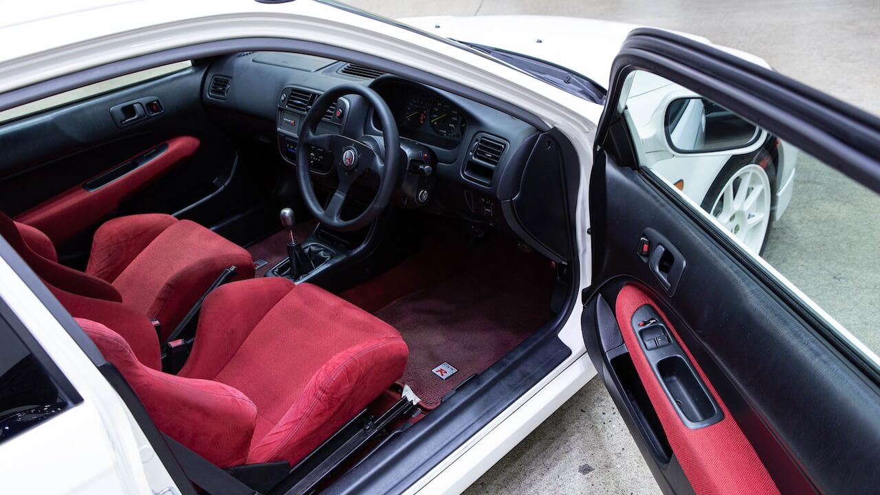 Red cloth sport seats cleaned during an interior detail