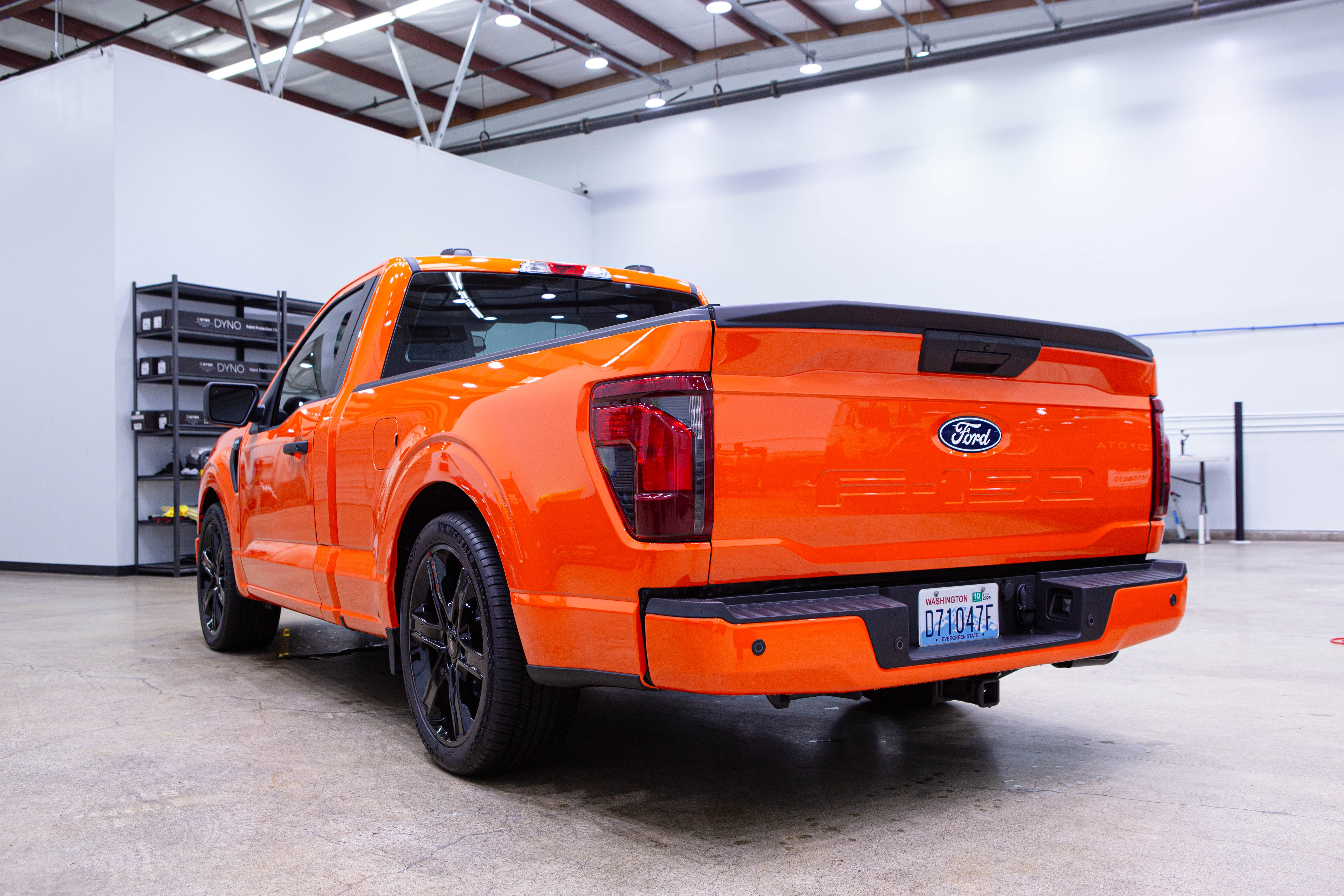 Orange pickup truck, rear three quarter