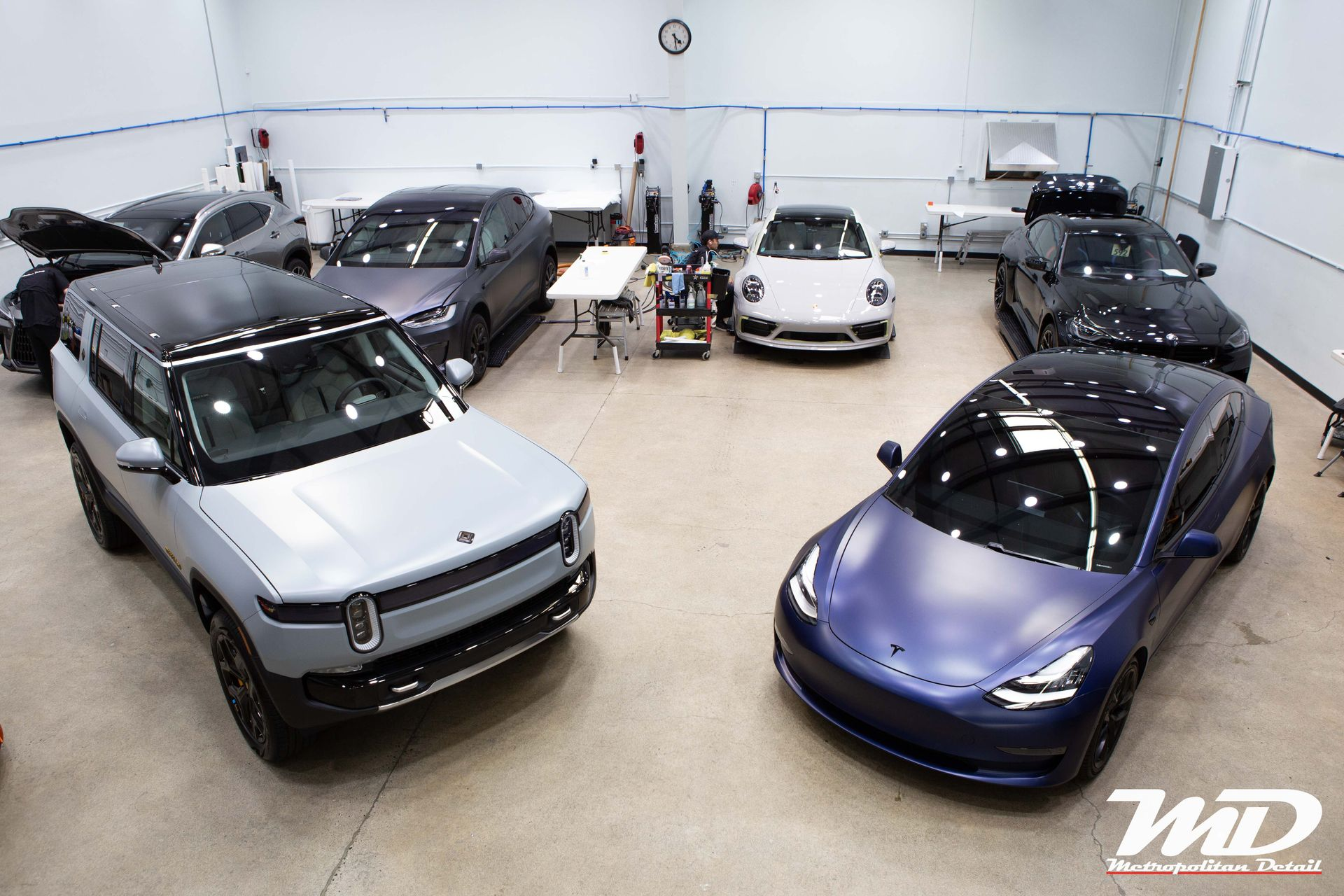 Rivian, Tesla, and Porsche EVs in the Metropolitan Detail studio in Redmond