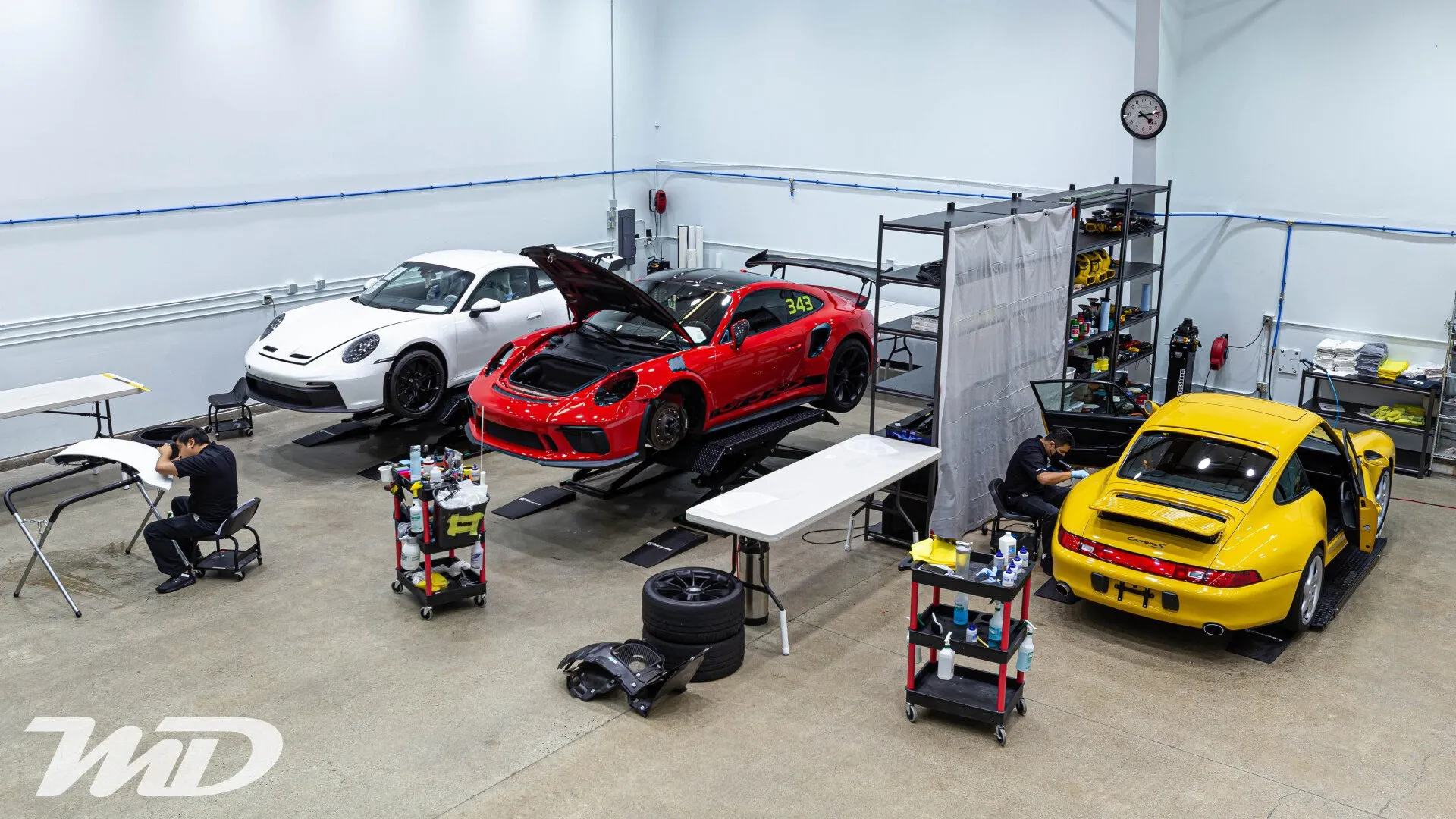 Porsches with wheels off during coating work at Metropolitan Detail in Redmond